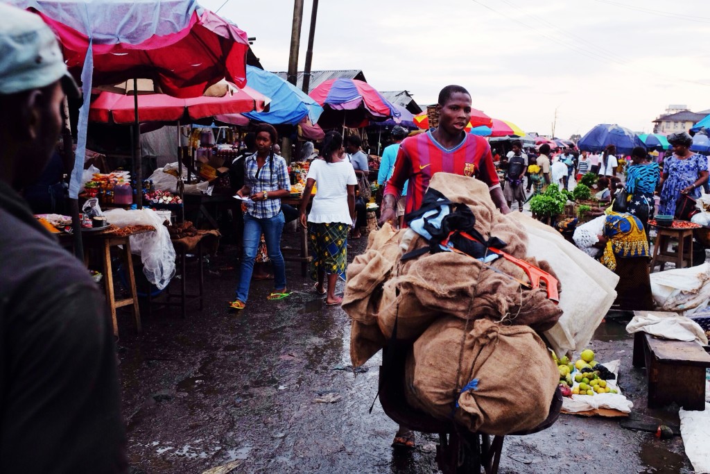 Man pushing a wheel barrow, Creek Road Market, Old Port Harcourt Township