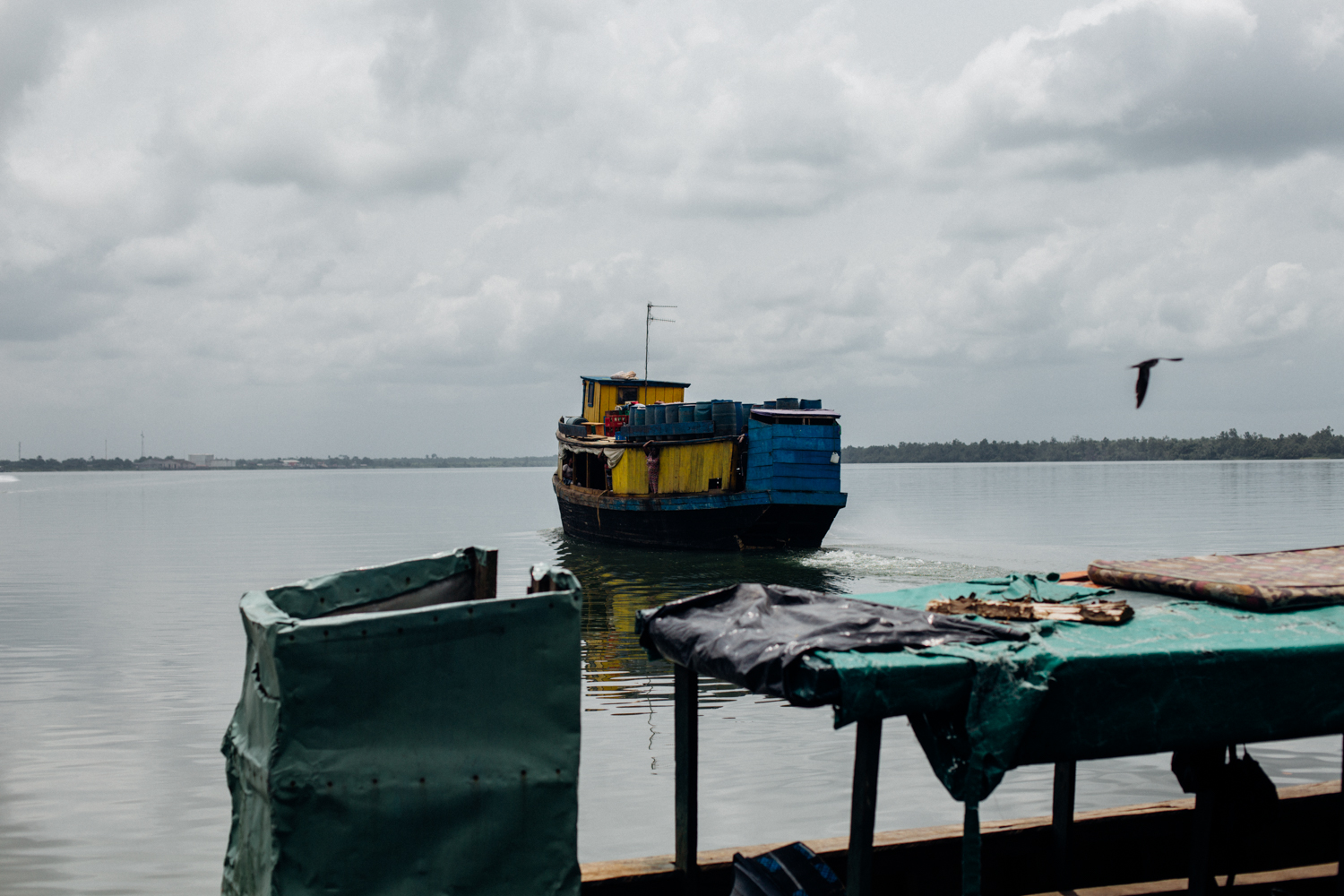 House boat leaving the floating market in Koko, Niger Delta