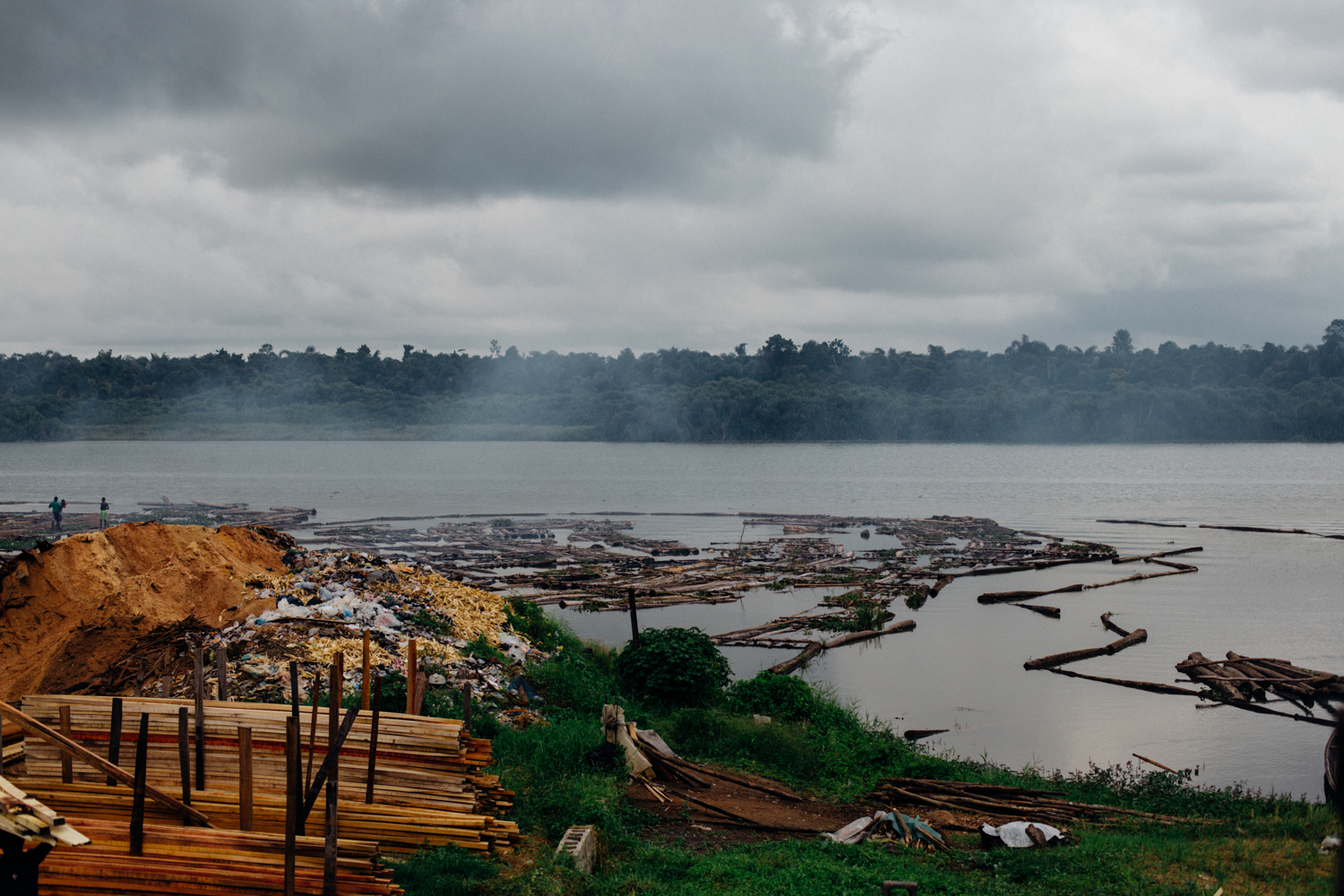 River Ethiope with logs of timber, sawdust and sawed timber in Sapele