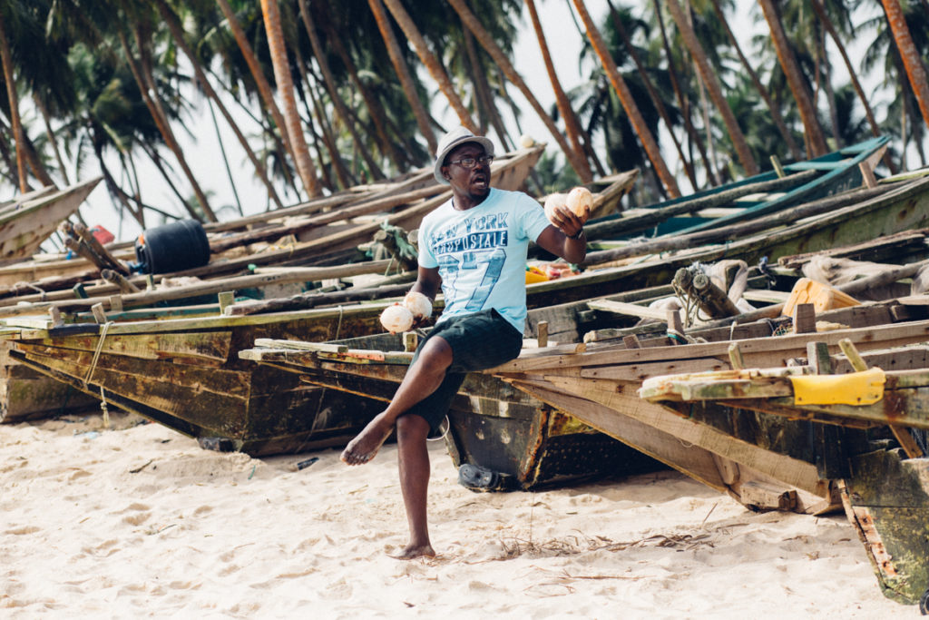 Portrait of man sitting on a canoe, Folu beach